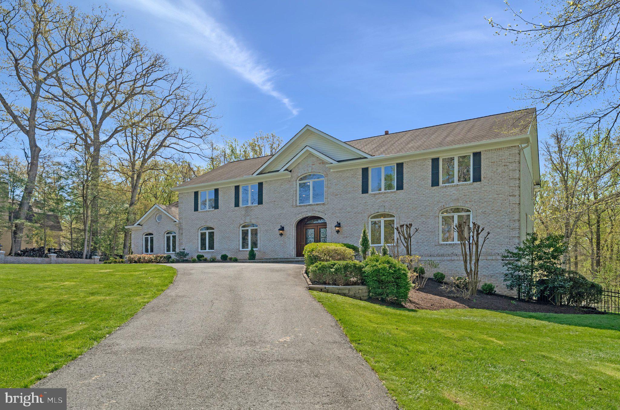 8611 Brook Road McLean, VA 22102 - Photo 6 of 104 a front view of a house with a garden and plants