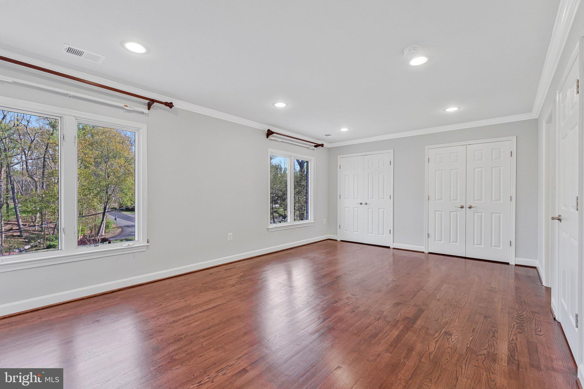 8611 Brook Road McLean, VA 22102 - Photo 61 of 104 a view of an empty room with wooden floor and a window