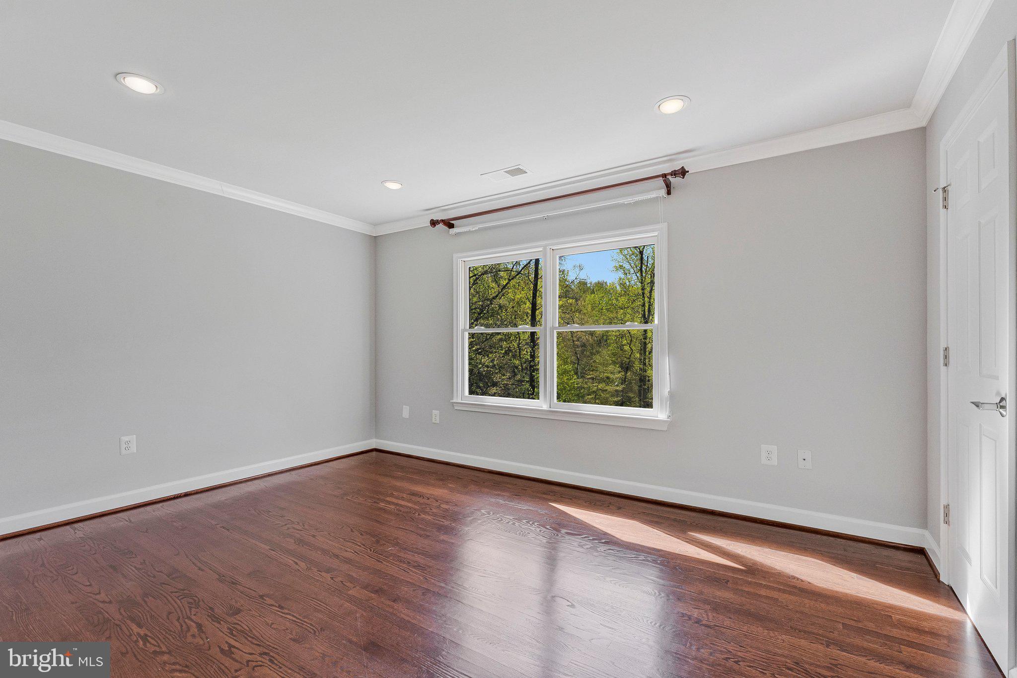 8611 Brook Road McLean, VA 22102 - Photo 66 of 104 a view of an empty room with wooden floor and a window