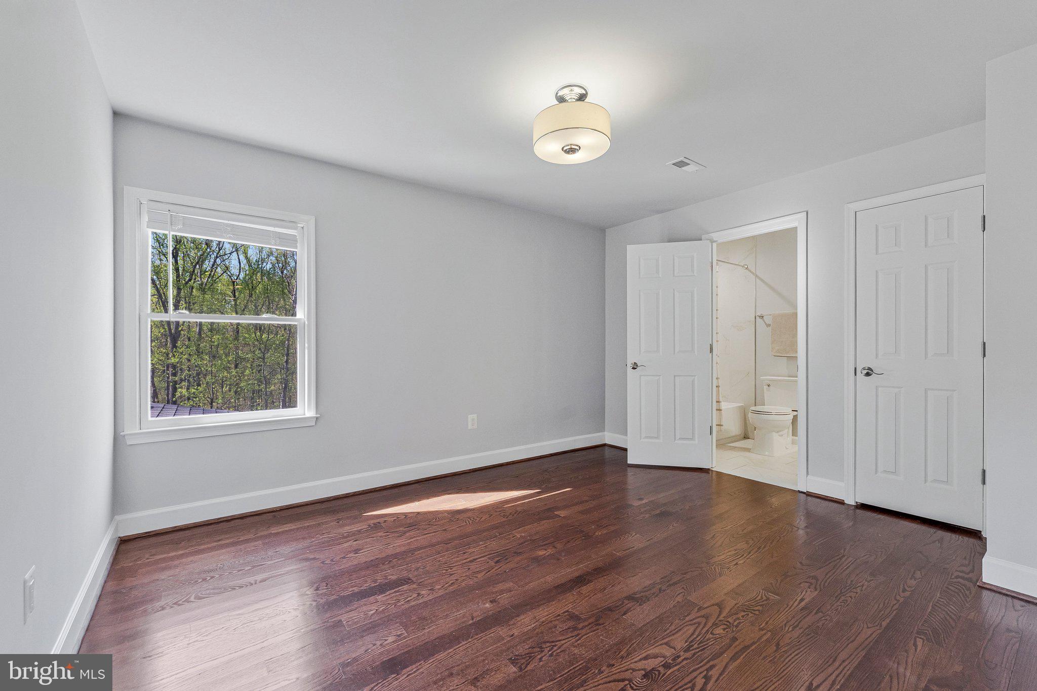 8611 Brook Road McLean, VA 22102 - Photo 69 of 104 a view of an empty room with wooden floor and a window