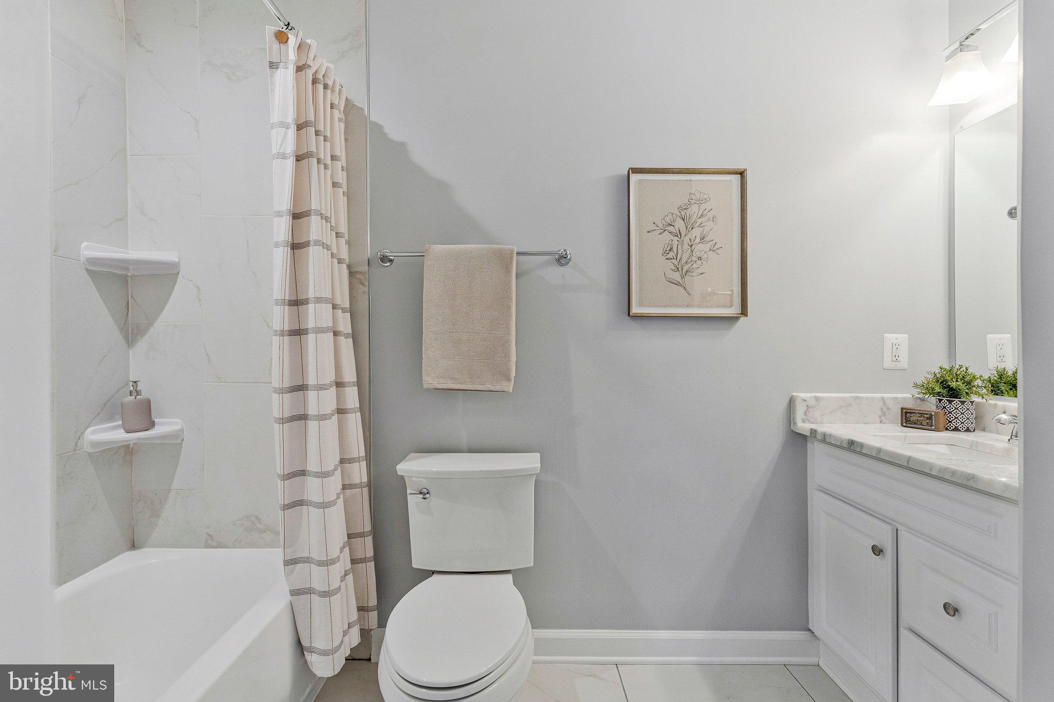 8611 Brook Road McLean, VA 22102 - Photo 71 of 104 a white toilet sitting next to a bathroom sink
