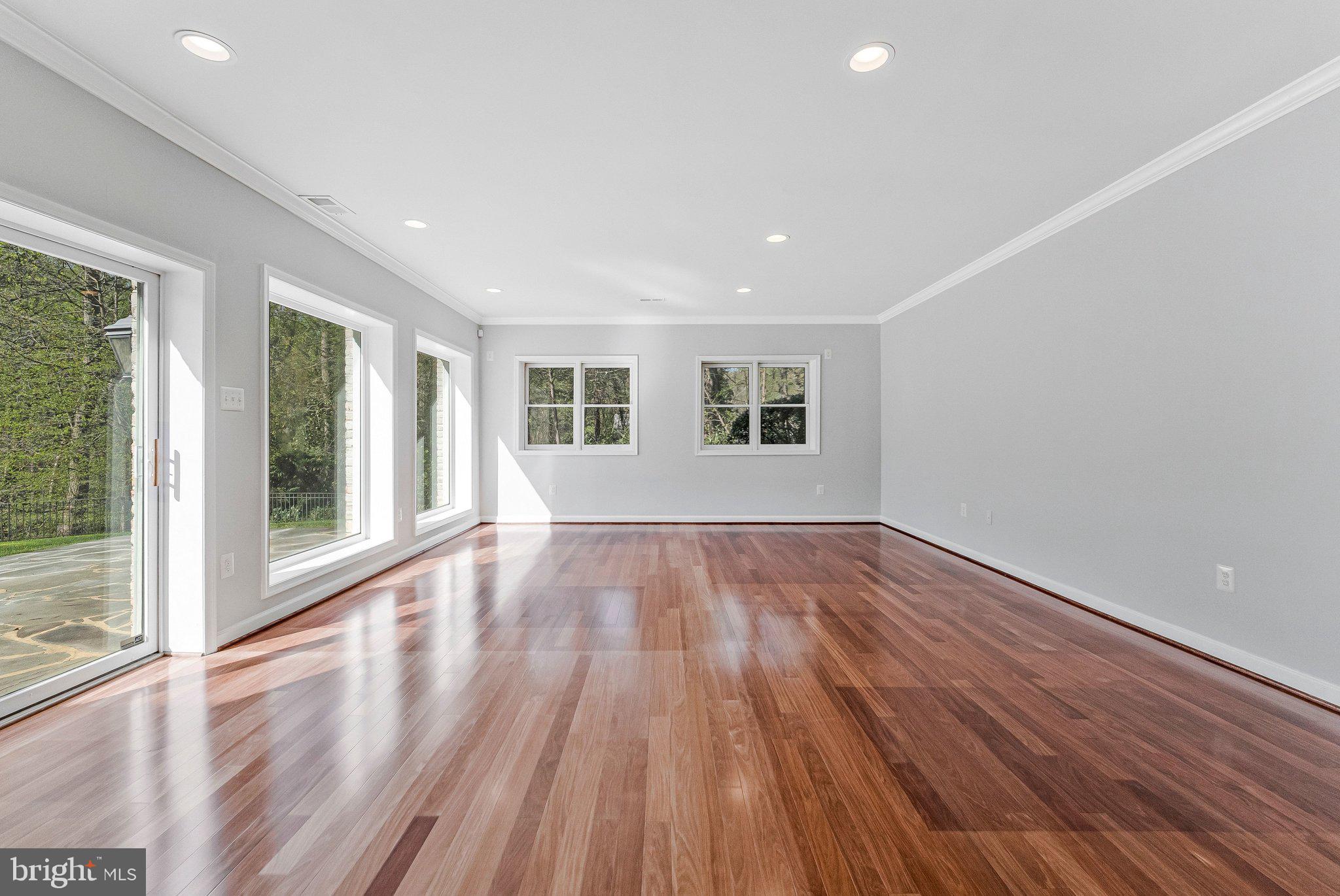 8611 Brook Road McLean, VA 22102 - Photo 82 of 104 a view of an empty room with wooden floor and a window