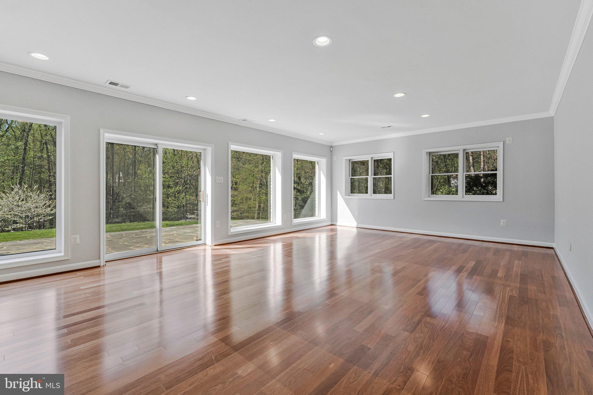 8611 Brook Road McLean, VA 22102 - Photo 83 of 104 a view of an empty room with wooden floor and a window