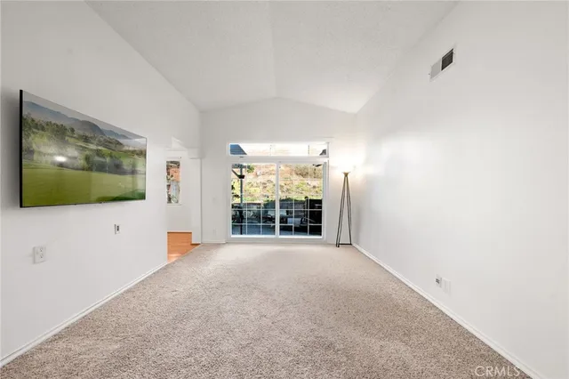 a view of a livingroom with an empty room and wooden floor