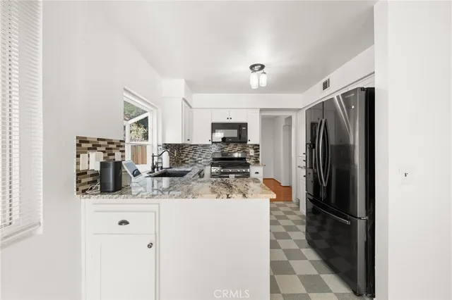 a kitchen that has a sink and a stove