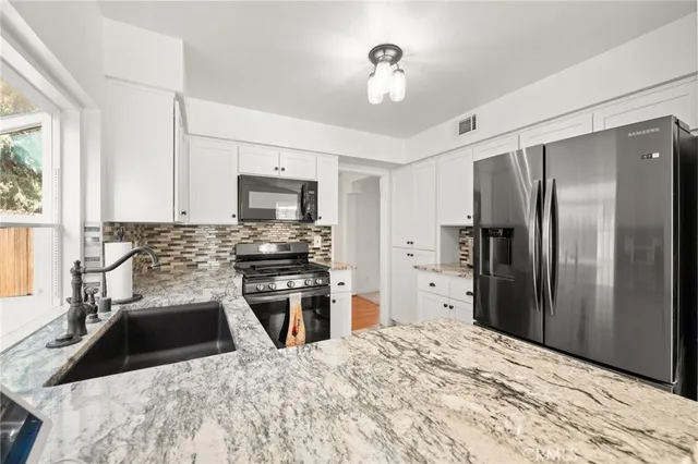 a kitchen with a refrigerator microwave and stove