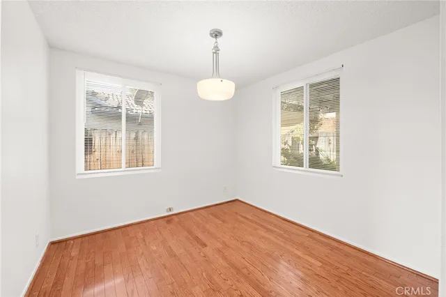 a view of a room with wooden floor and a window
