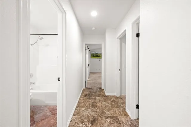 a view of a patio with couches and table and chairs and potted plants
