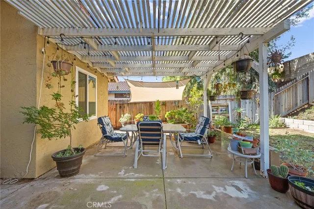 a view of a pathway of a house with wooden fence