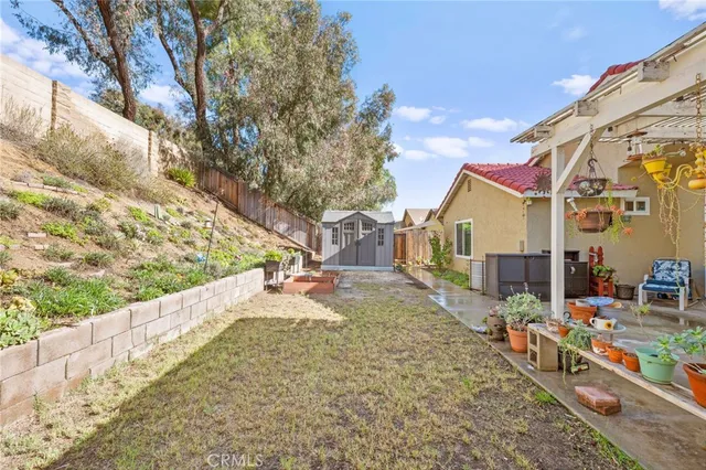a view of a house with a yard and wooden fence