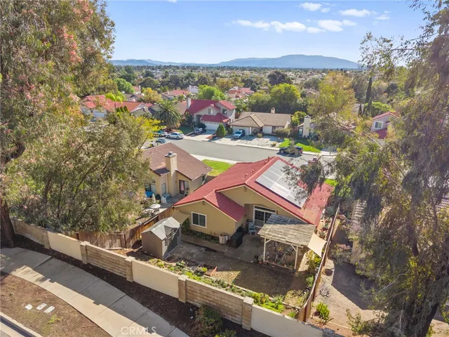 an aerial view of residential houses with outdoor space and swimming pool