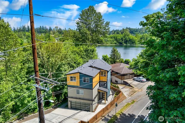 an aerial view of a house with swimming pool and outdoor seating