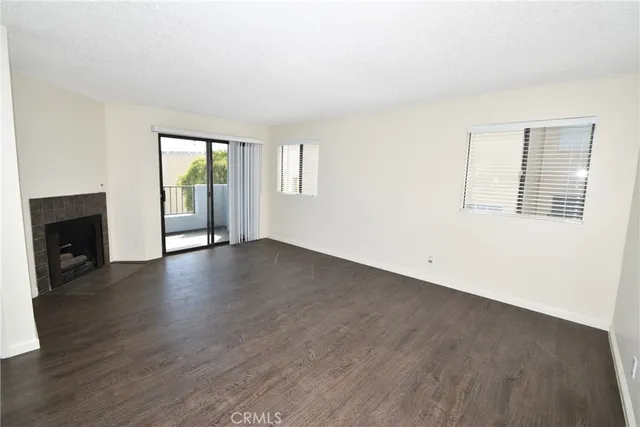 an empty room with wooden floor and a window