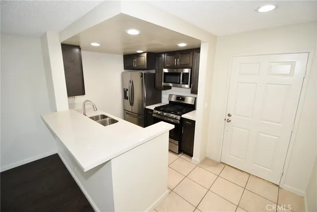 a kitchen with a refrigerator and a sink