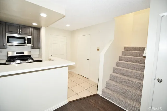 a hallway with stairs and wooden floor
