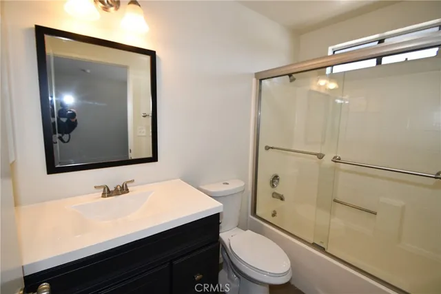 a bathroom with a toilet a sink and a mirror
