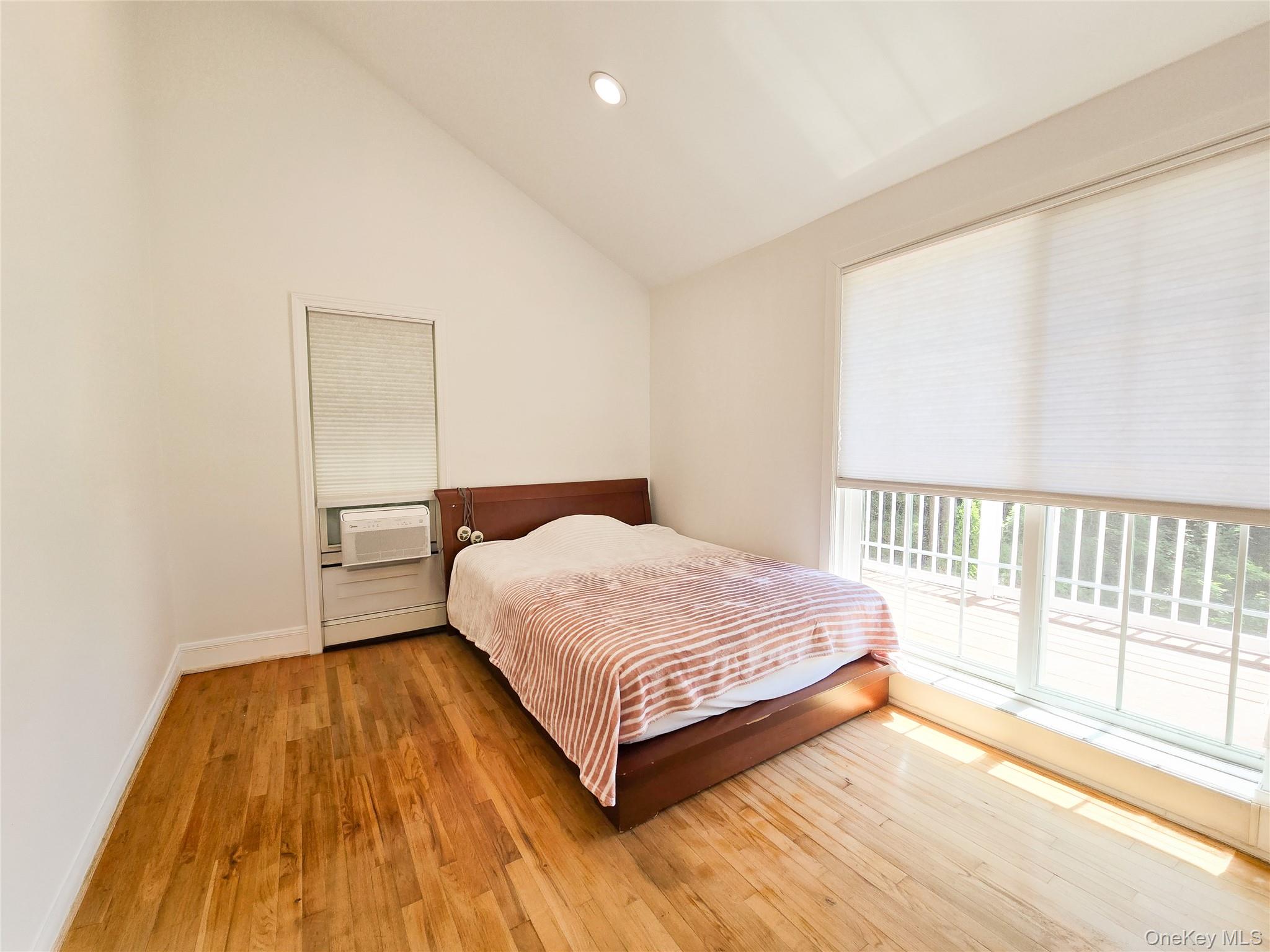 249 Cold Spring Road Syosset, NY 11791 - Photo 15 of 28 a bedroom with a bed and a large window