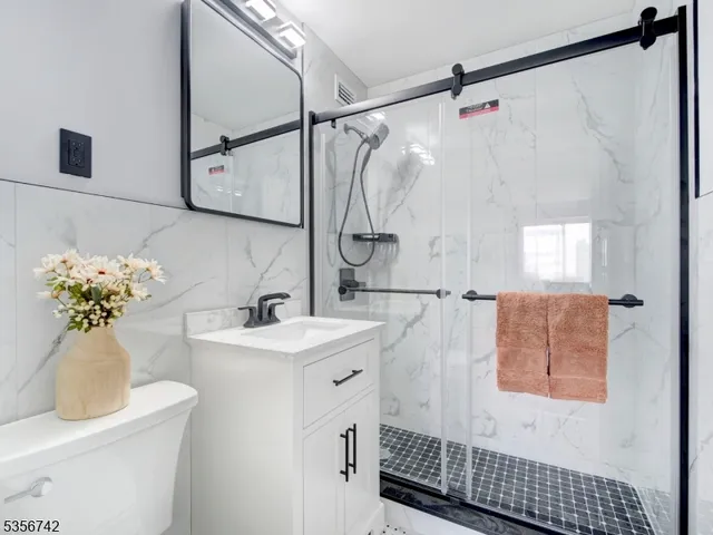 a bathroom with a sink toilet and mirror