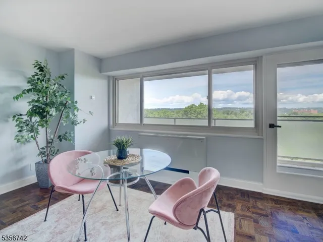 a dining room with furniture window and wooden floor