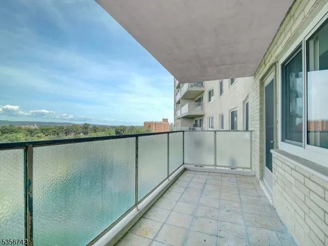 a kitchen with stainless steel appliances granite countertop a refrigerator a sink a stove and cabinets