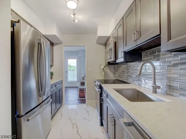 a kitchen with stainless steel appliances granite countertop a sink and cabinets