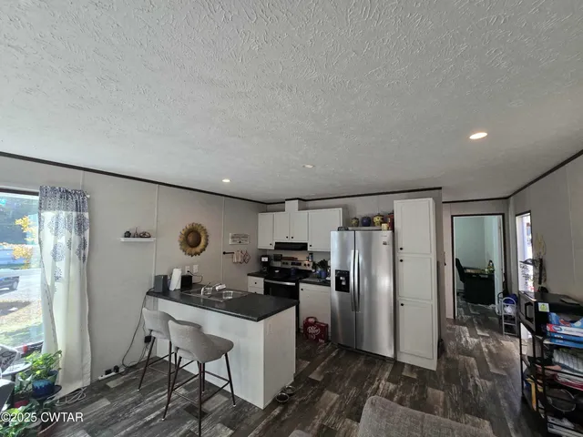 a kitchen with refrigerator cabinets and furniture