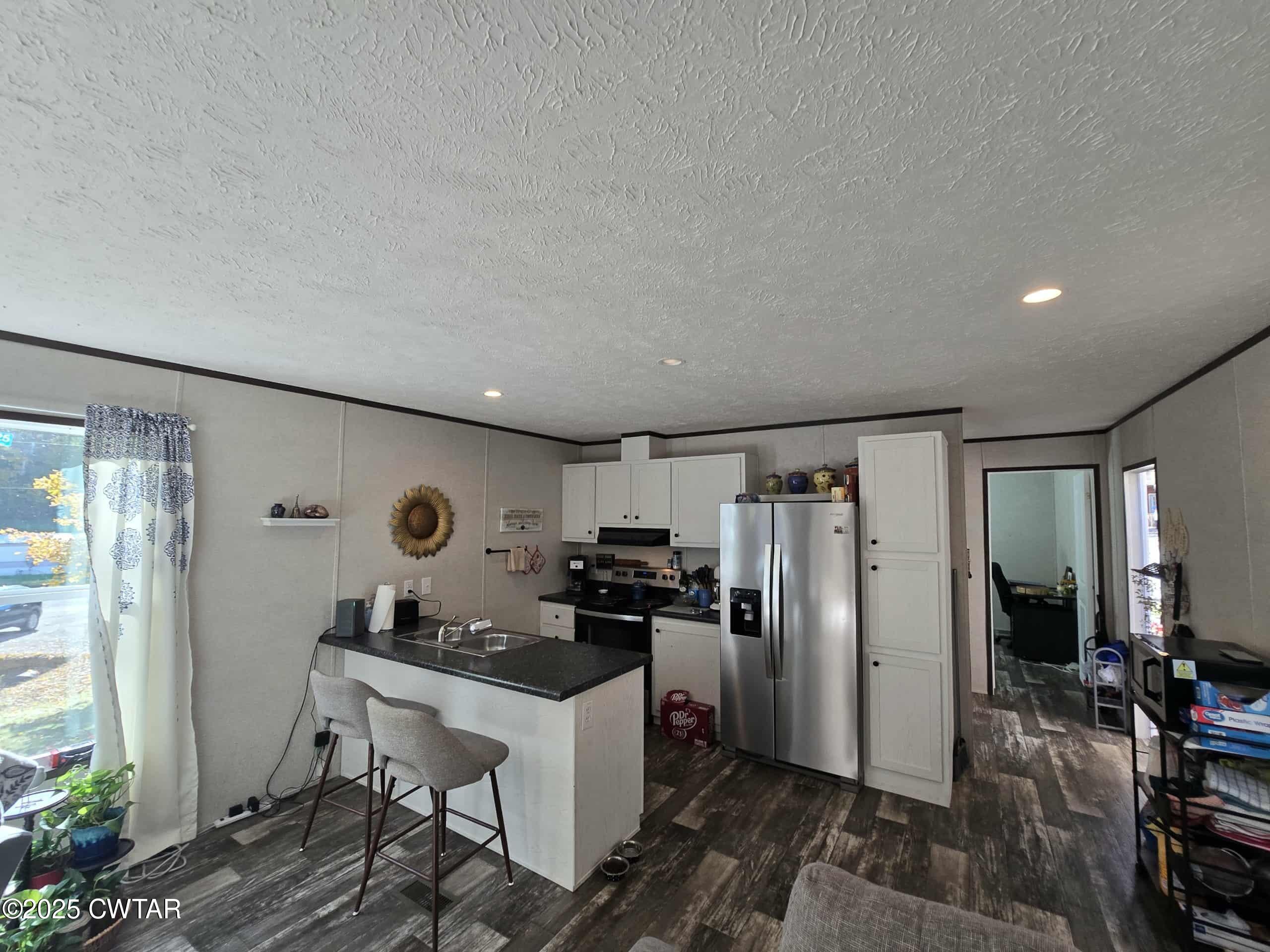 263 Porter Hollow Road Linden, TN 37096 - Photo 4 of 20 a kitchen with refrigerator cabinets and furniture