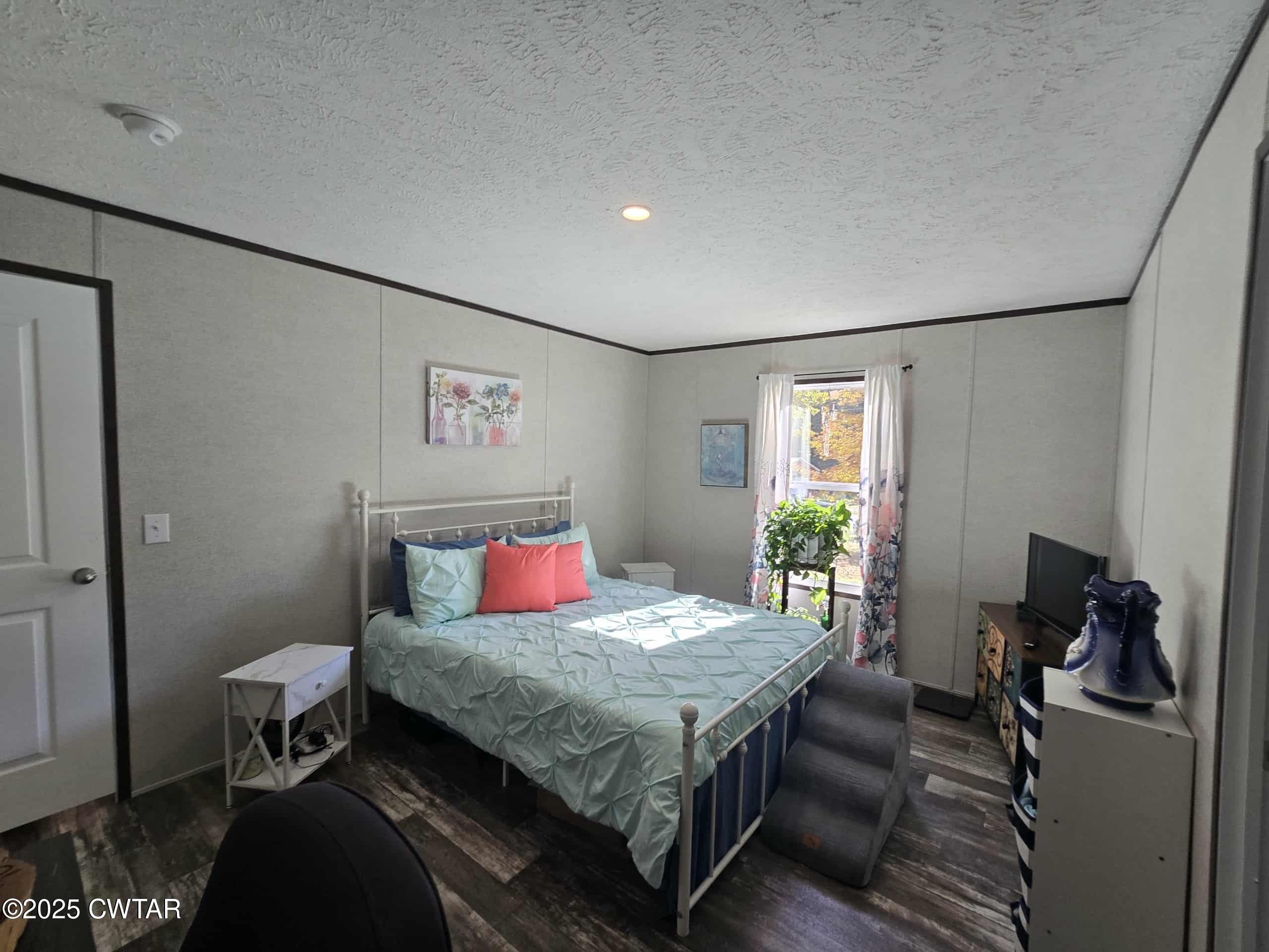 263 Porter Hollow Road Linden, TN 37096 - Photo 6 of 20 a bedroom with a bed and wooden floor