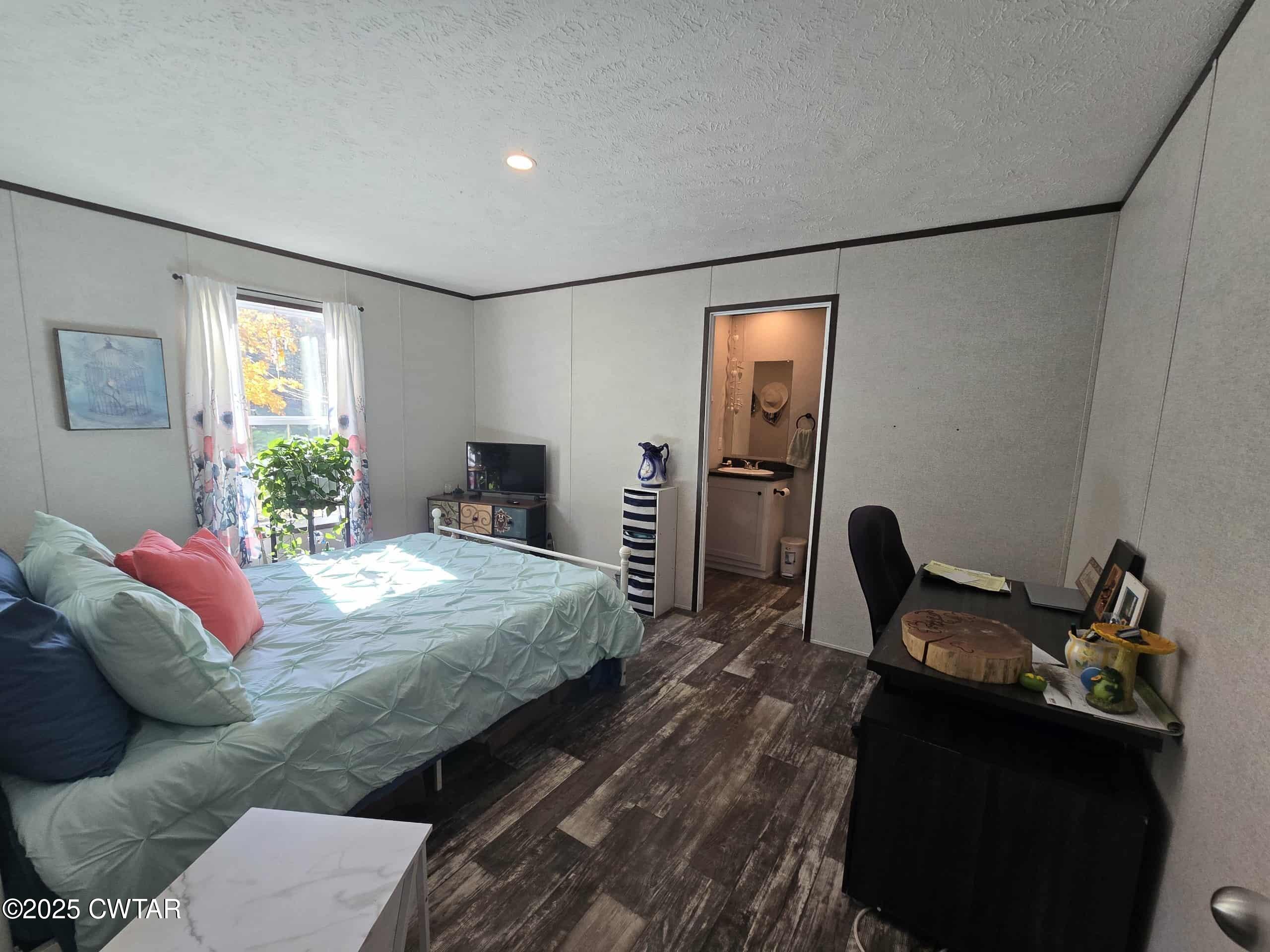 263 Porter Hollow Road Linden, TN 37096 - Photo 7 of 20 a bedroom with a bed and wooden floor