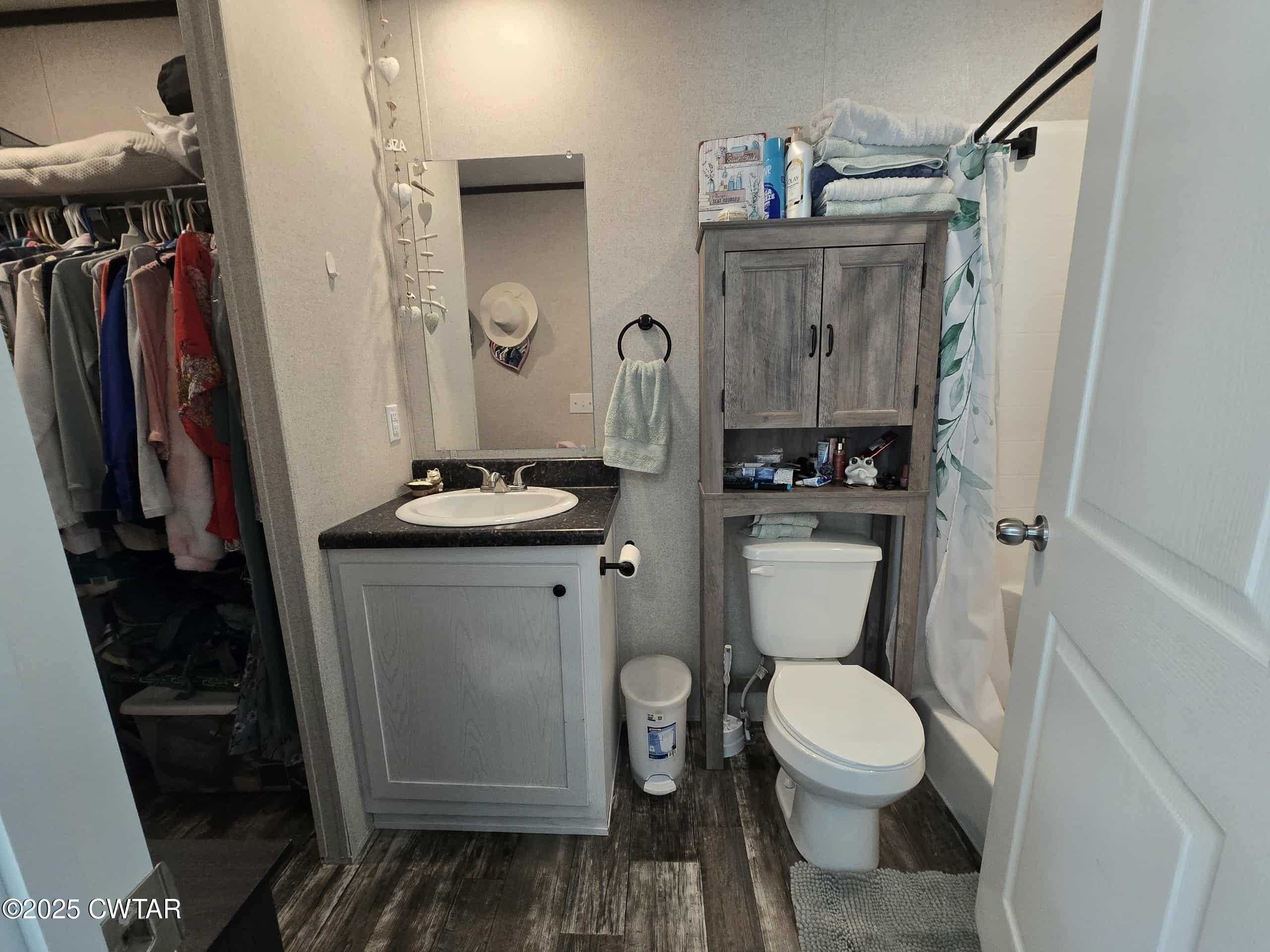 263 Porter Hollow Road Linden, TN 37096 - Photo 8 of 20 a bathroom with a toilet a sink and shower