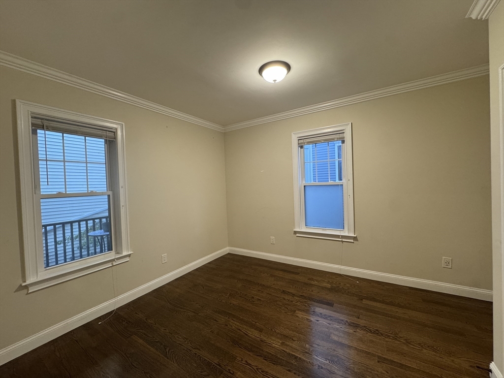 9 Cornwall Street, Unit 1 Boston, MA 02130 - Photo 14 of 22 a view of an empty room with wooden floor and a window
