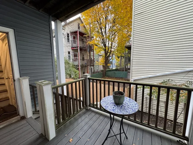 a view of a balcony with a table and chairs