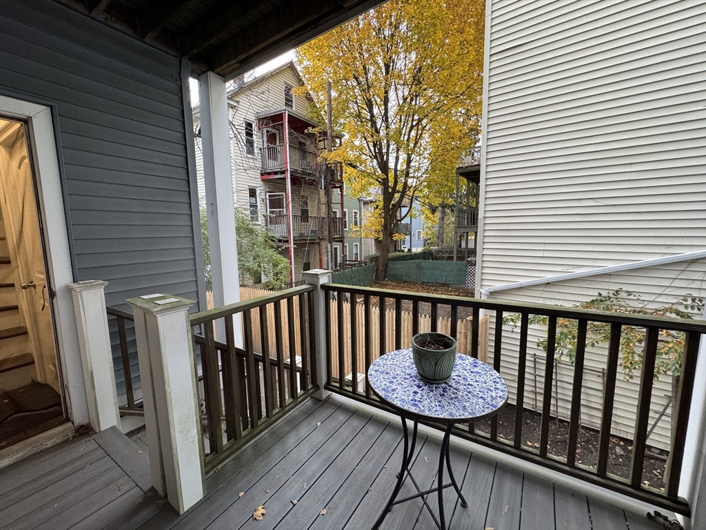 9 Cornwall Street, Unit 1 Boston, MA 02130 - Photo 18 of 22 a view of a balcony with a table and chairs