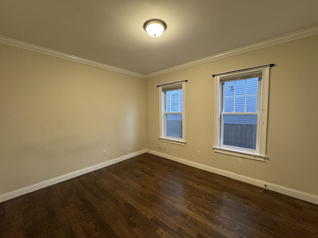 9 Cornwall Street, Unit 1 Boston, MA 02130 - Photo 7 of 22 a view of an empty room with wooden floor and a window