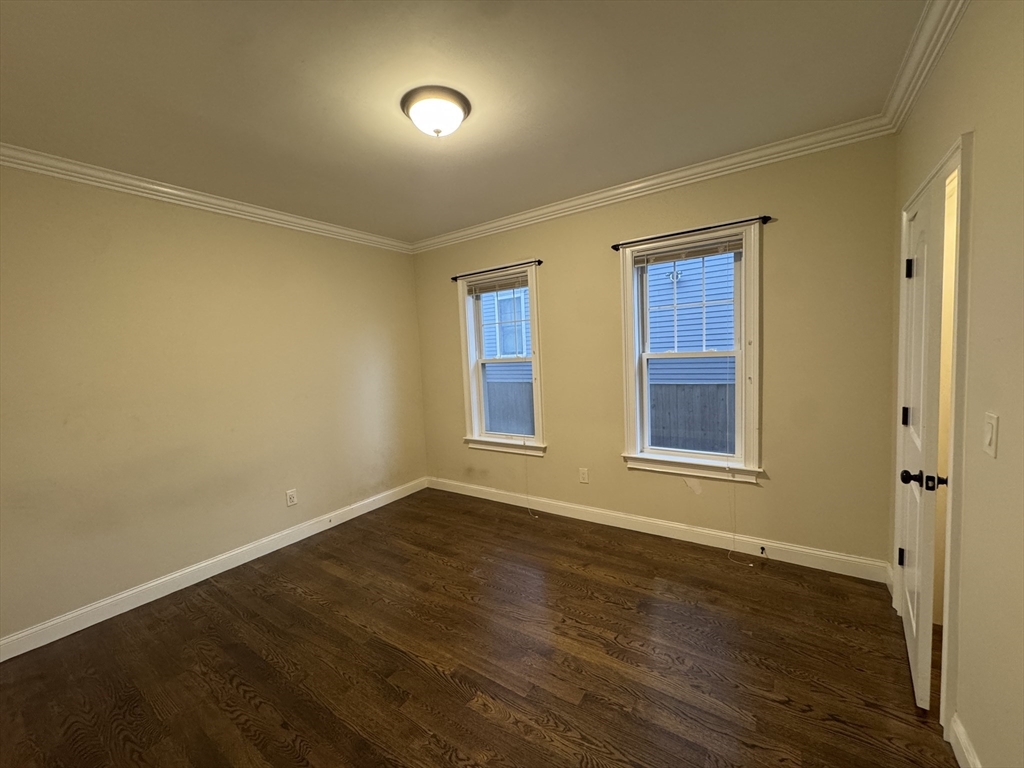 9 Cornwall Street, Unit 1 Boston, MA 02130 - Photo 8 of 22 a view of an empty room with wooden floor and a window
