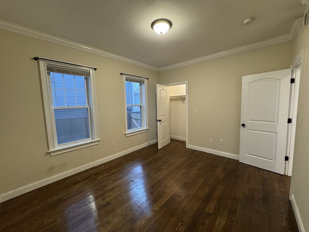 9 Cornwall Street, Unit 1 Boston, MA 02130 - Photo 10 of 22 an empty room with wooden floor and windows