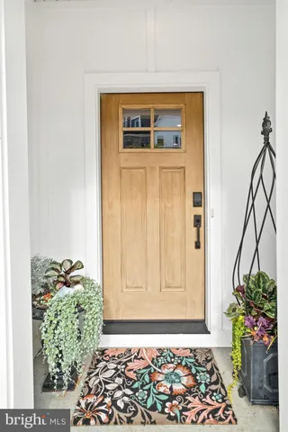 a front view of a house with a window and a table with chairs