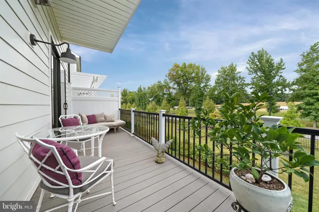 a view of a chairs and table in patio with wooden fence