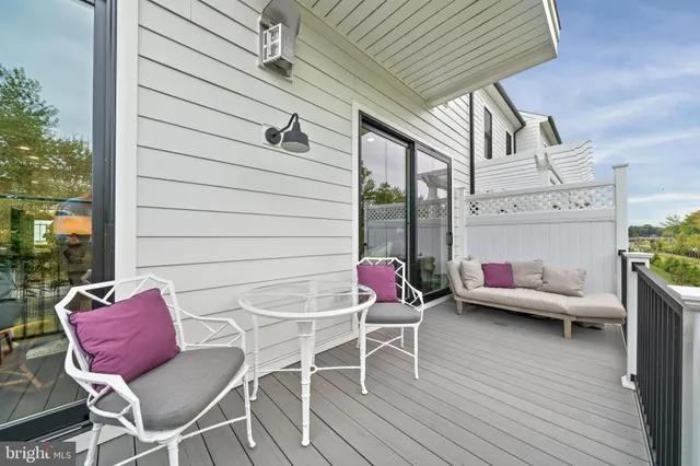 a living room with fireplace furniture and a large window