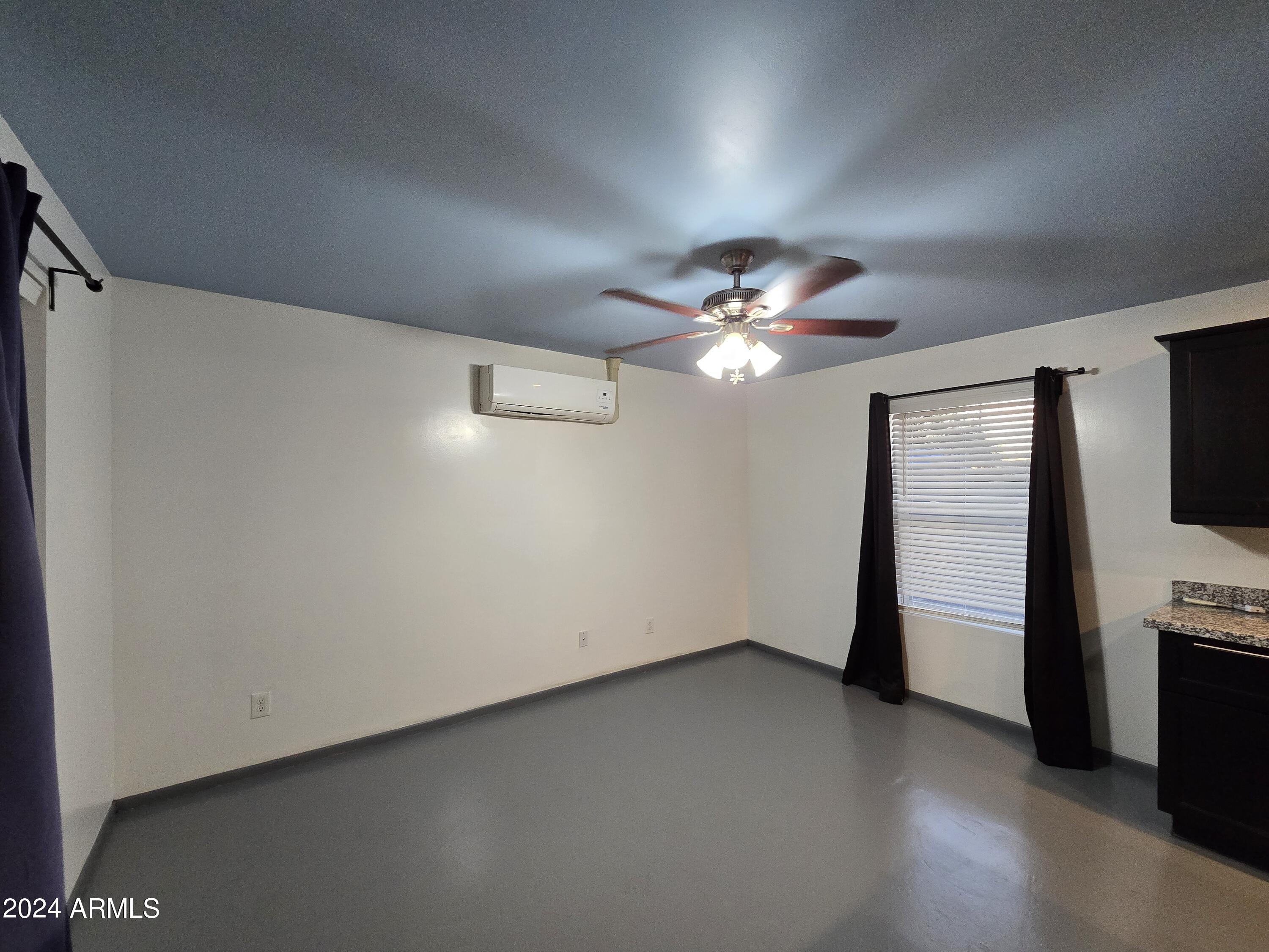 2302 North 36th Street, Unit 2 Phoenix, AZ 85008 - Photo 2 of 11 a view of a livingroom with a ceiling fan window and a ceiling fan
