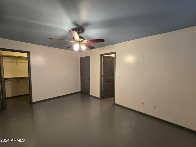 a view of a livingroom with a ceiling fan and window