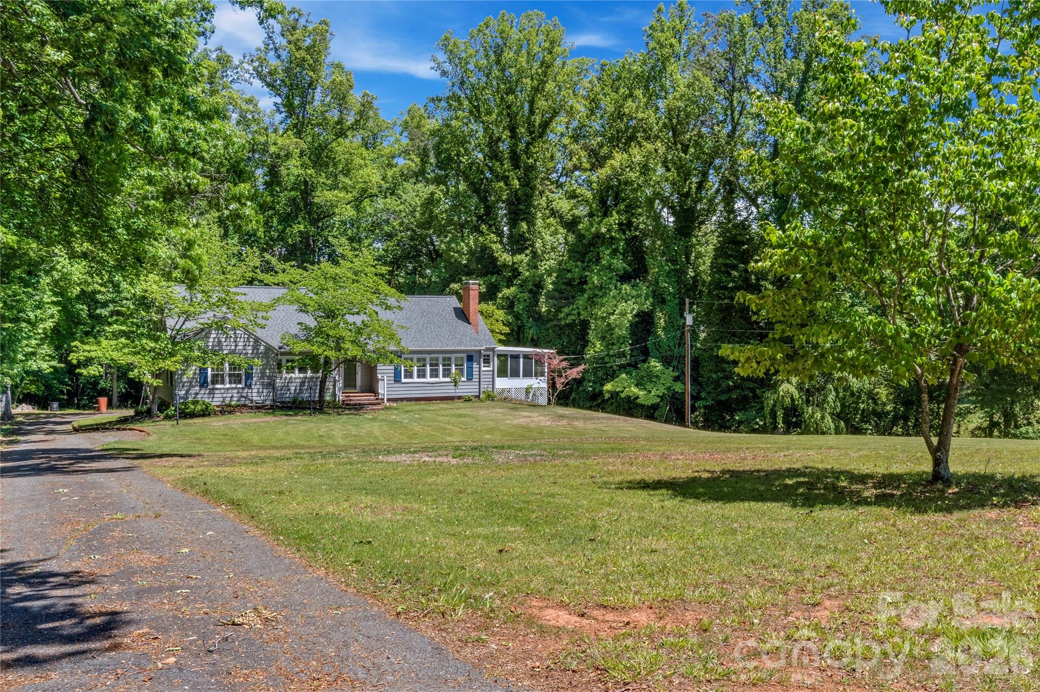 951 Dodson Mill Road Pilot Mountain, NC 27041 - Photo 4 of 48 a yellow and red house with a big yard and large trees