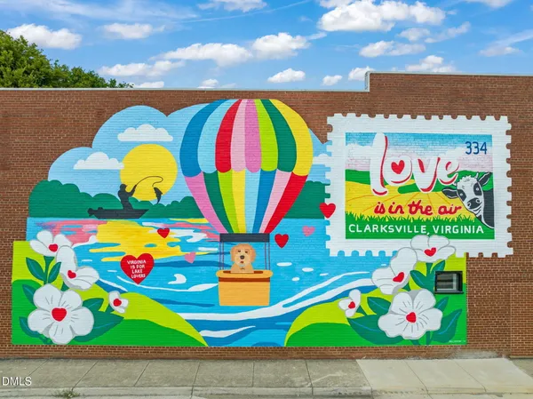 an aerial view of a house with a garden and lake view