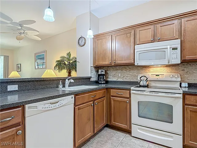 a kitchen with cabinets stainless steel appliances and a sink