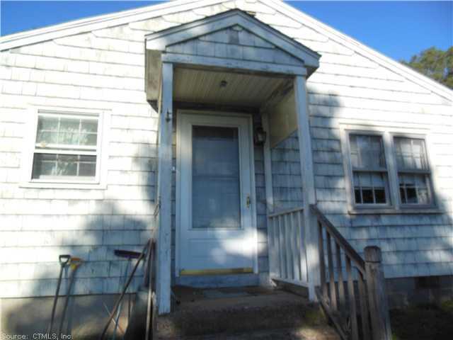 a view of front door of house with wooden floor