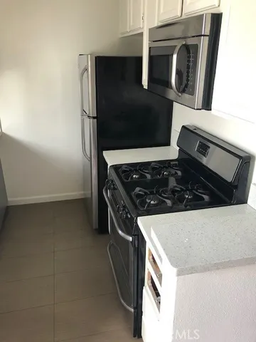 a kitchen with a sink and a refrigerator
