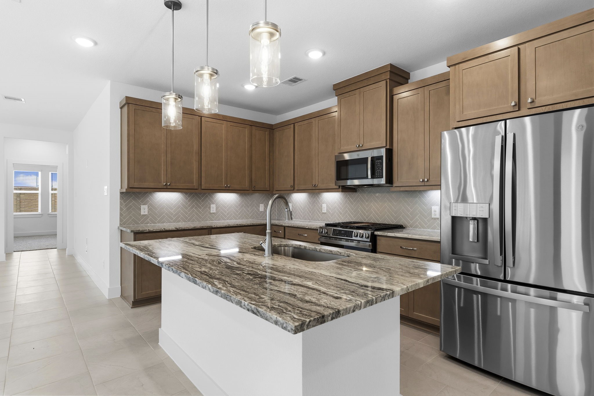 5251 Celestial Court Rosharon, TX 77583 - Photo 14 of 46 a kitchen with stainless steel appliances granite countertop a refrigerator a stove a sink and a microwave