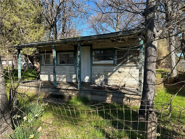 a view of house with swimming pool and sitting area