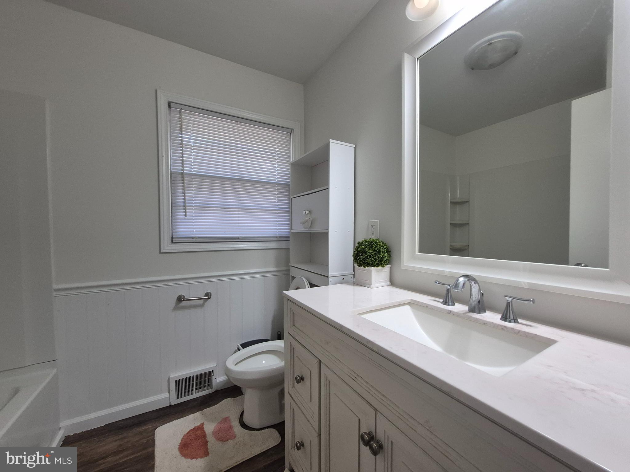 707 West Morris Leonard Road Salisbury, MD 21804 - Photo 12 of 22 a bathroom with a sink toilet vanity and window