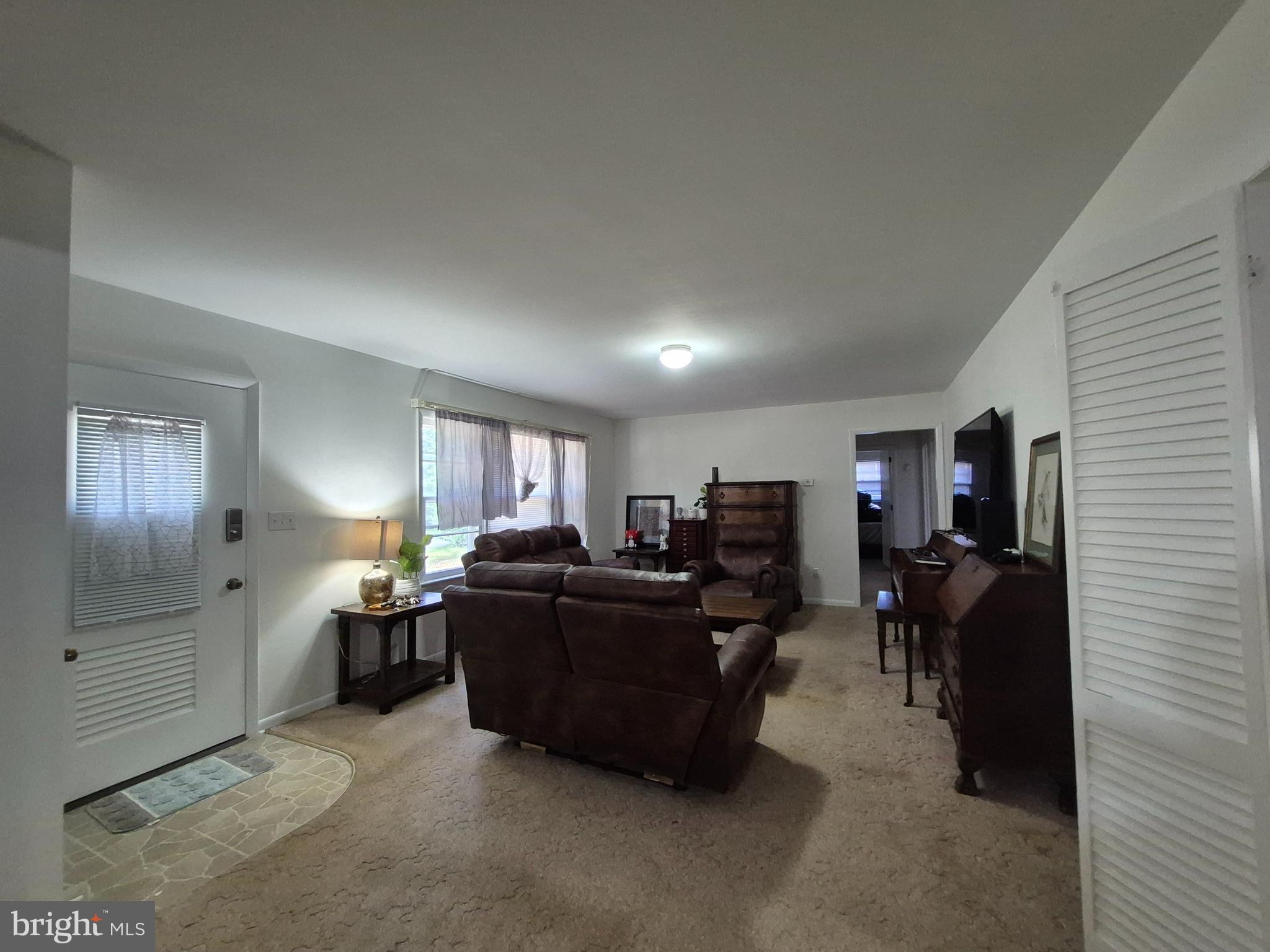 707 West Morris Leonard Road Salisbury, MD 21804 - Photo 2 of 22 a living room with furniture and a flat screen tv